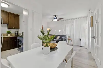 a kitchen and living room with a white table and chairs at 1 Block to Sand Stylish Boho Retreat in San Diego