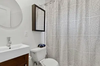 a bathroom with a toilet and a shower curtain at 1 Block to Sand Stylish Boho Retreat in San Diego