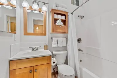 a bathroom with a sink and a toilet and a shower at 1 Block to the Sand Stylish & Spacious Studio! in San Diego
