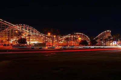 a large building lit up at night with lights at PB 1BR BOHO with Parking, AC, and Large Patio in San Diego
