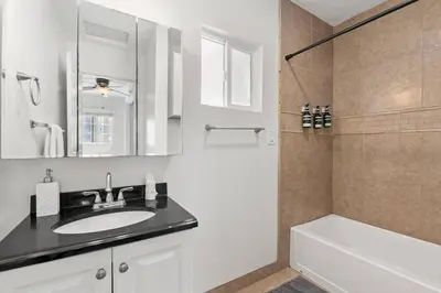 a bathroom with a sink and a shower and a tub at PB 1BR BOHO with Parking, AC, and Large Patio in San Diego