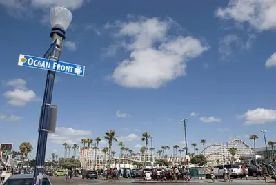 a street sign on a light pole in a parking lot at PB 1BR BOHO with Parking, AC, and Large Patio in San Diego
