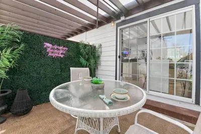a white table and chairs on a patio at PB 1BR BOHO with Parking, AC, and Large Patio in San Diego