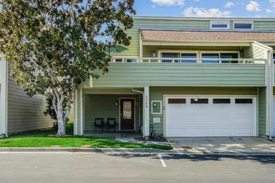 a green house with a white garage at Encinitas Paradise | Seabluffe Gated Community w/ Beach Access in Encinitas