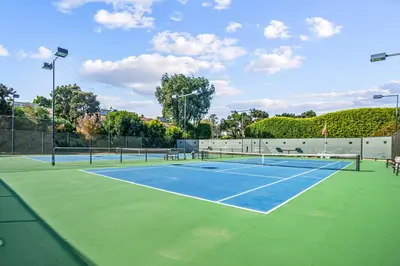 a tennis court with two tennis courts at Encinitas Paradise | Seabluffe Gated Community w/ Beach Access in Encinitas