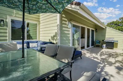 a patio with a table and chairs and an umbrella at Encinitas Paradise | Seabluffe Gated Community w/ Beach Access in Encinitas