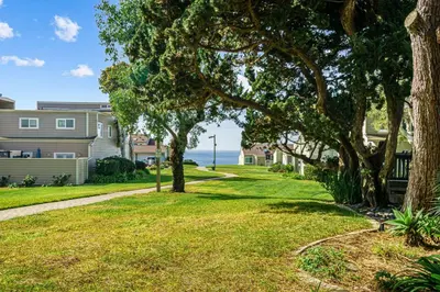a lawn with trees in front of a house at Encinitas Paradise | Seabluffe Gated Community w/ Beach Access in Encinitas