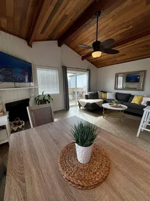a living room with a table and a couch at Newport Beach Rendezvous in Newport Beach