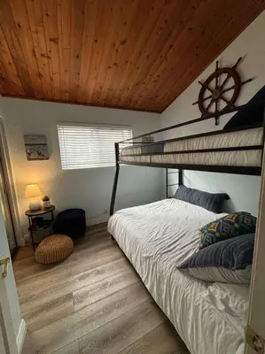 a bedroom with a bunk bed with a clock on the ceiling at Newport Beach Rendezvous in Newport Beach