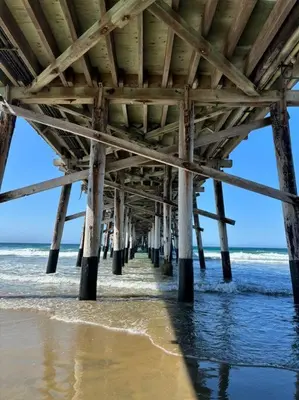 a pier on the beach near the water at Newport Beach Rendezvous in Newport Beach