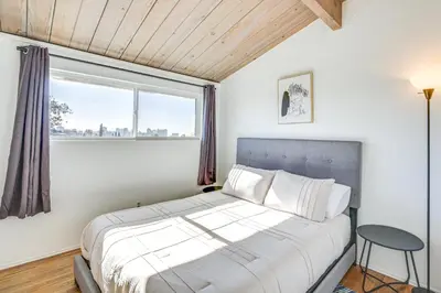 a bedroom with a large bed and a window at 3 Mi to Balboa Park Water-View Condo with Balcony in San Diego