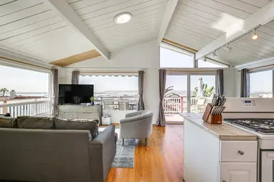 a kitchen and living room with a view of the ocean at 3 Mi to Balboa Park Water-View Condo with Balcony in San Diego