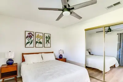 a bedroom with a bed and a ceiling fan at Water-View Home with Hot Tub in Lake Elsinore! in Lake Elsinore