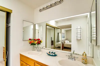 a bathroom with a sink and a large mirror at Water-View Home with Hot Tub in Lake Elsinore! in Lake Elsinore