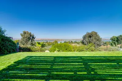 a grassy field with shadows on the grass at Water-View Home with Hot Tub in Lake Elsinore! in Lake Elsinore