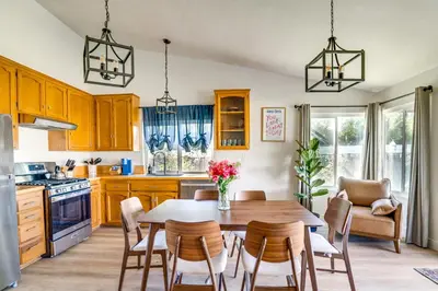 a kitchen with a wooden table and chairs and a dining room at Water-View Home with Hot Tub in Lake Elsinore! in Lake Elsinore