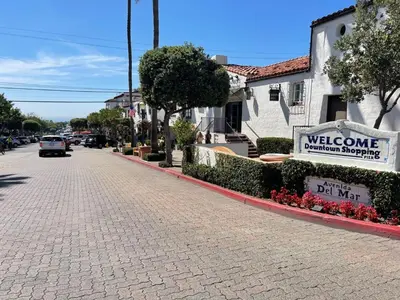 a cobblestone street with a welcome sign and a building at Walk To Beach 2BR Top Location - AA in San Clemente