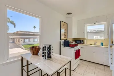 a kitchen with a table and a large window at Walk to Beach - KING Apt In #1 Area - AB in San Clemente