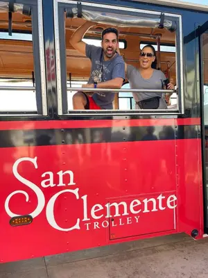 two people are sitting on a red bus at Walk to Beach - KING Apt In #1 Area - AB in San Clemente