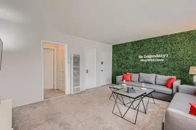 a living room with a couch and a table at Walk to Beach - KING Apt In #1 Area - AC in San Clemente
