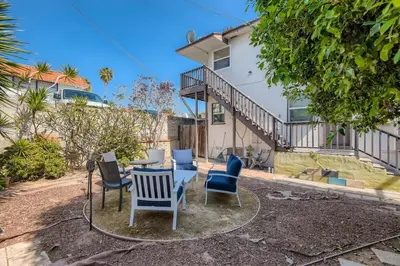 a table and chairs in the backyard of a house at Walk to Beach - KING Apt In #1 Area - AC in San Clemente