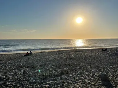 a group of people sitting on a beach with the ocean at Walk to Beach - KING Apt In #1 Area - AC in San Clemente