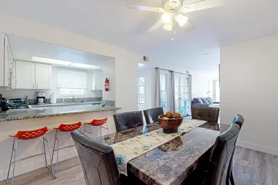 a kitchen and dining room with a table and chairs at Stroll to Shore and Mission Blvd Dog-Friendly Home in San Diego