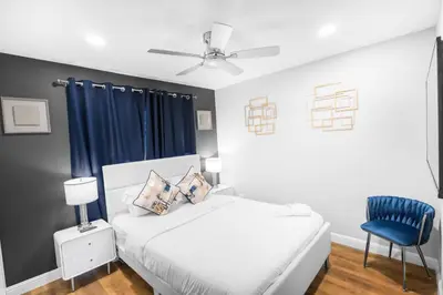a bedroom with a bed and a blue chair at Gillespie Drive 1063 Unit B by sdstay in Spring Valley