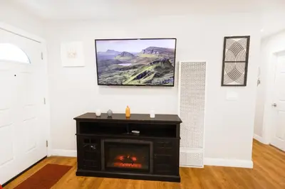 a living room with a fireplace and a tv on the wall at Gillespie Drive 1063 Unit B by sdstay in Spring Valley