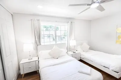 a white room with two beds and a window at Gillespie Drive 1063 Unit B by sdstay in Spring Valley