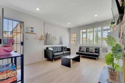 a living room with two couches and a table at Double Flamingo HotTub BBQ Game Room Self Check-in in San Diego