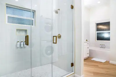 a shower with a glass door in a bathroom at Newly Built Coastal Home with Yard in San Diego