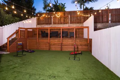 a backyard with a horse arena with lights and grass at Newly Built Coastal Home with Yard in San Diego