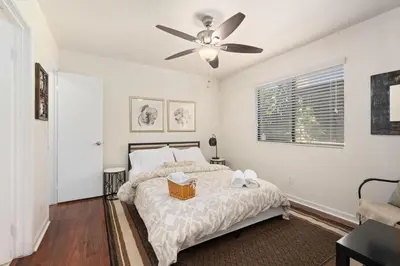 a bedroom with a bed with a ceiling fan at Mission Hills Dream - BBQ, Patios, AC, Parking in San Diego