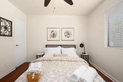a bedroom with a bed with white walls and a window at Mission Hills Dream - BBQ, Patios, AC, Parking in San Diego
