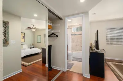 a bedroom with a bed and a bathroom with a window at Mission Hills Dream - BBQ, Patios, AC, Parking in San Diego