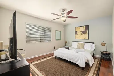 a bedroom with a bed and a ceiling fan at Mission Hills Dream - BBQ, Patios, AC, Parking in San Diego
