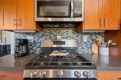 a kitchen with a stove and a microwave at Mission Hills Dream - BBQ, Patios, AC, Parking in San Diego