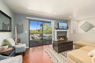 a living room with a fireplace and a couch at Mission Hills Dream - BBQ, Patios, AC, Parking in San Diego