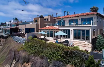 a house on top of a hill next to a beach at Oceanfront Paradise - Luxury, Fire Pit, Views in San Diego
