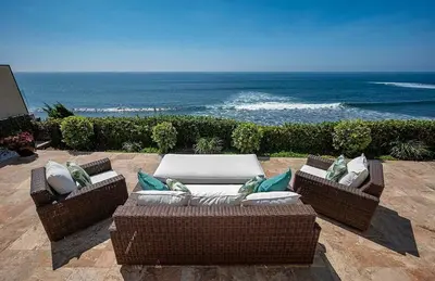 two wicker couches sitting on a patio overlooking the ocean at Oceanfront Paradise - Luxury, Fire Pit, Views in San Diego