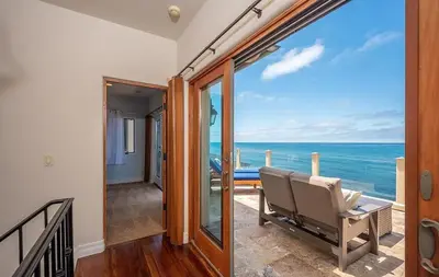 a room with a balcony with a view of the ocean at Oceanfront Paradise - Luxury, Fire Pit, Views in San Diego