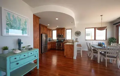 a kitchen with a table and a dining room at Oceanfront Paradise - Luxury, Fire Pit, Views in San Diego