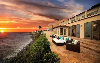 a house on the beach with a sunset at Oceanfront Paradise - Luxury, Fire Pit, Views in San Diego