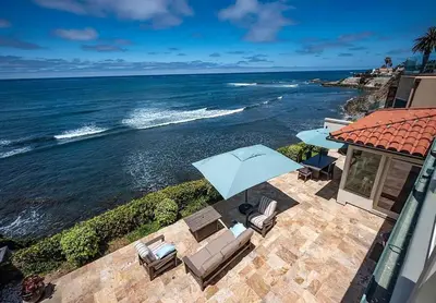 a view of the ocean with chairs and an umbrella at Oceanfront Paradise - Luxury, Fire Pit, Views in San Diego