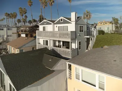 an aerial view of a white house with palm trees at Beachfront Bliss | Shining Sea Condo on The Strand w/ Ocean Views in Oceanside
