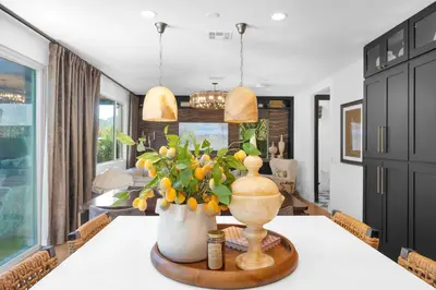 a dining room with a table with a vase of flowers at # Marbella Lane - Stylish Dream Home in RMV with Pool in Mission Viejo