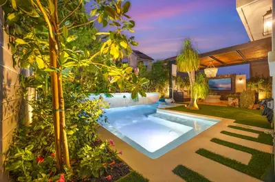 a swimming pool in a yard with plants at # Marbella Lane - Stylish Dream Home in RMV with Pool in Mission Viejo