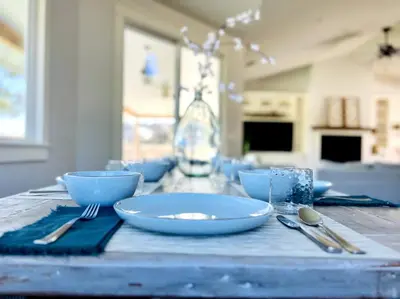 a table with blue bowls and silverware on it at Getaway Retreat Close to Temecula San Diego LA in Murrieta