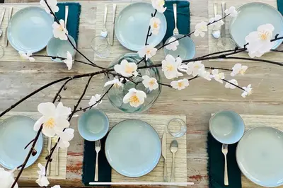 a table with blue plates and flowers on it at Getaway Retreat Close to Temecula San Diego LA in Murrieta